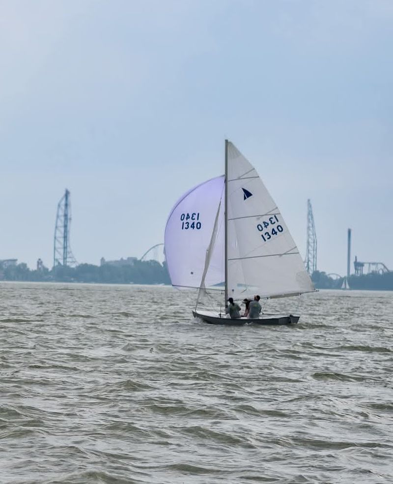 Mad Cow sailing under spinnaker on grey water, sail number 1340
